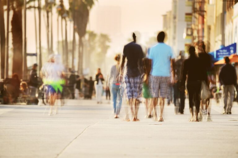 Motion blurred pedestrians on boardwalk in Venice Beach