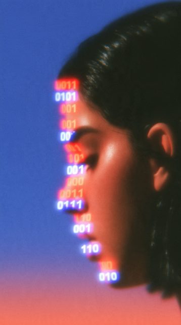 artistic render of facial recognition scanning portrays binary code on the surface of a woman's face
